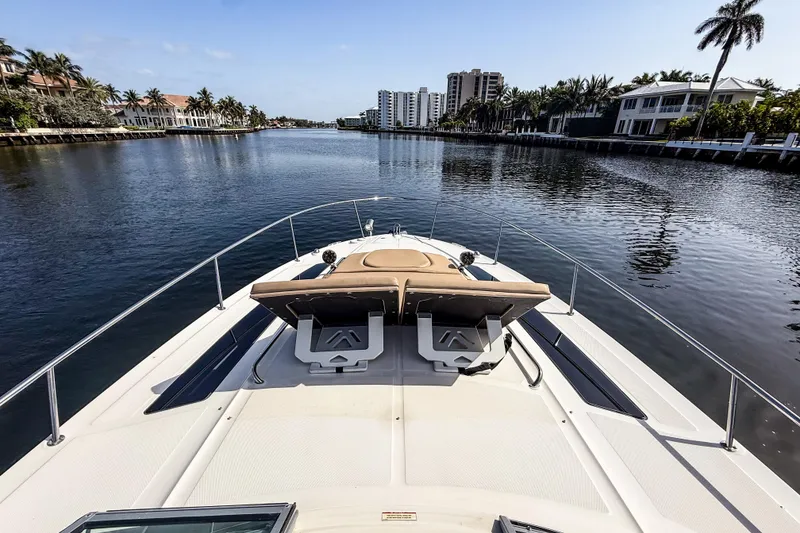 Slide: The Image of 2016 Sea Ray Sundancer 350 cruising on a scenic waterway with palm trees and buildings. - 38