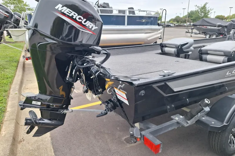 Slide: The Image of 2023 Lowe Skorpion 17 boat with Mercury outboard motor in a parking lot. - 13