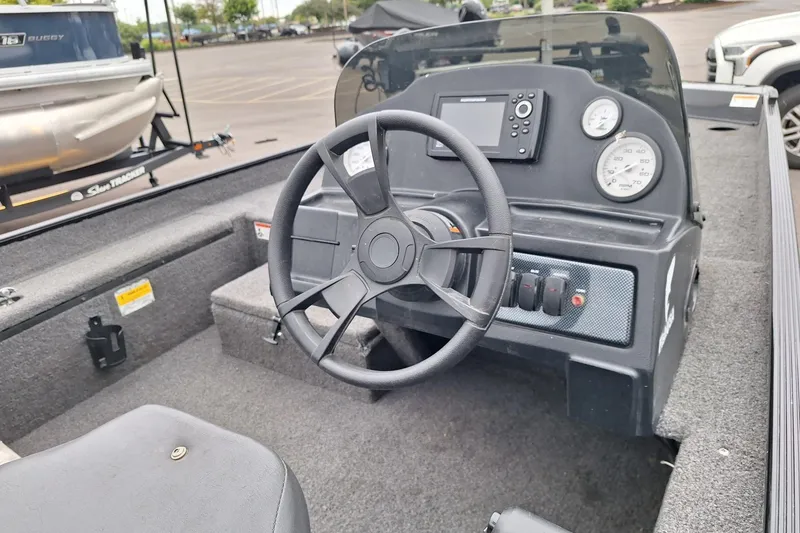 Slide: The Image of 2023 Lowe Skorpion 17 boat dashboard with steering wheel and gauges. - 15