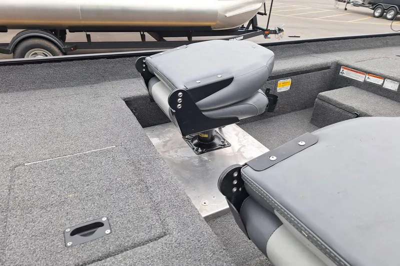 Slide: The Image of 2023 Lowe Skorpion 17 boat interior with dual gray seats and carpeted flooring. - 16