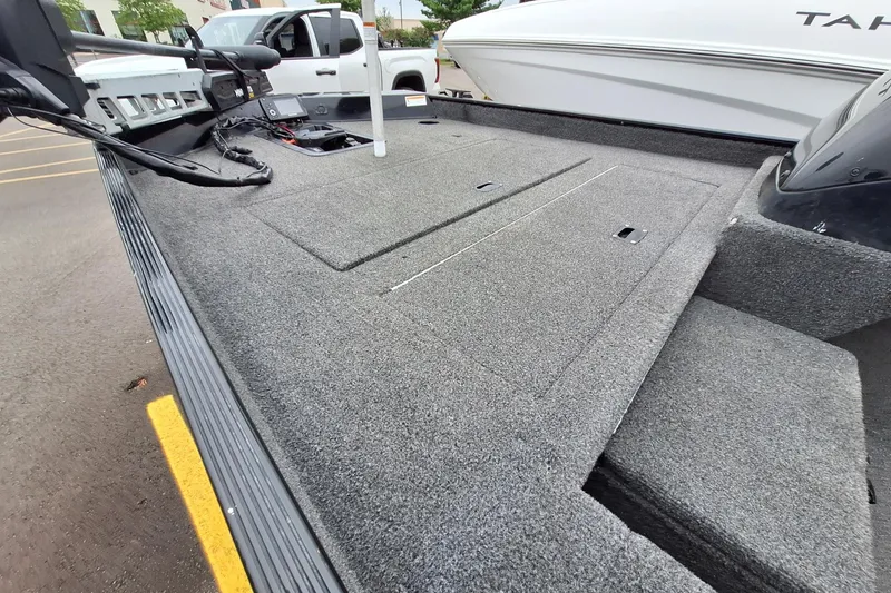 Slide: The Image of 2023 Lowe Skorpion 17 boat deck with carpeted surface and storage compartments. - 20