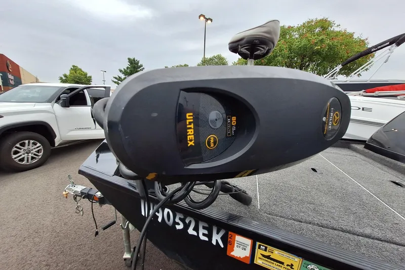 Slide: The Image of 2023 Lowe Skorpion 17 boat with Ultrex motor, parked near a white truck. - 22