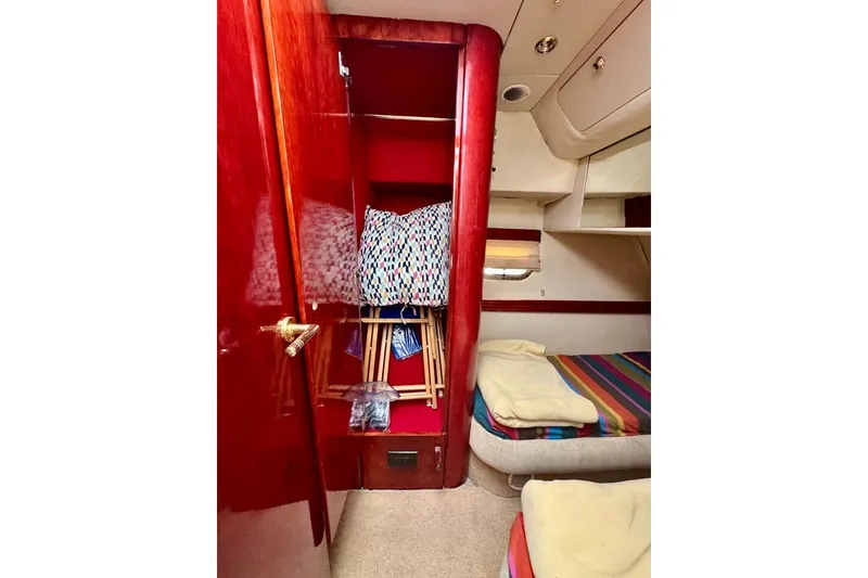 Slide: The Image of Interior of 1999 Birchwood Challenger 450 Flybridge with colorful bedding and wooden cabinetry. - 37