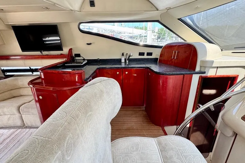 Slide: The Image of Luxurious interior of 1999 Birchwood Challenger 450 Flybridge yacht with elegant wood cabinetry. - 24