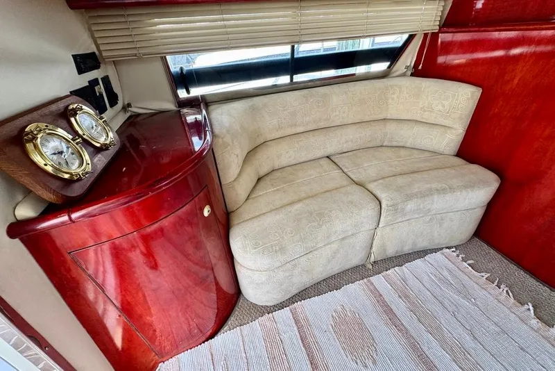 Slide: The Image of Luxurious interior of 1999 Birchwood Challenger 450 Flybridge with elegant seating and wooden cabinetry. - 13