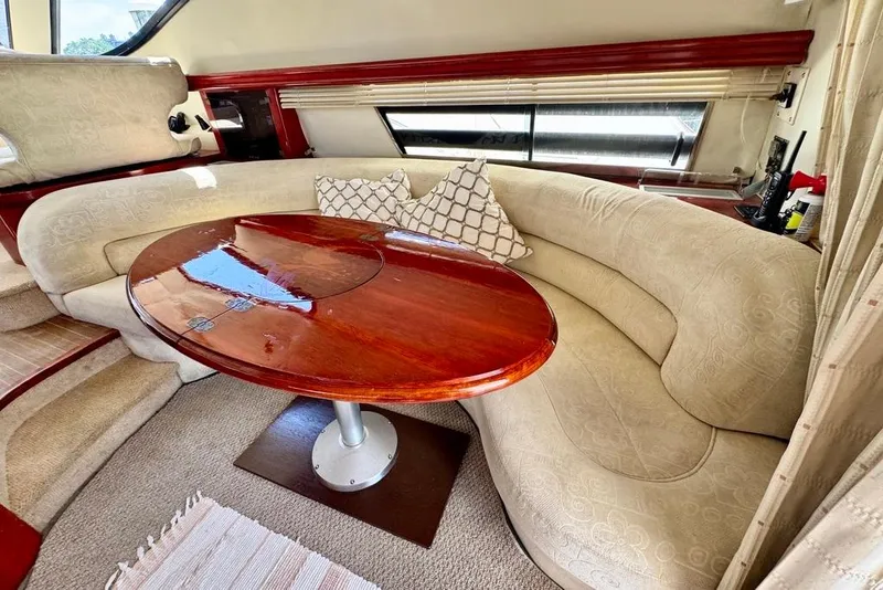Slide: The Image of Luxurious interior of 1999 Birchwood Challenger 450 Flybridge with elegant seating and wooden table. - 15