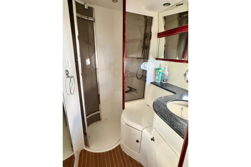 Slide: The Image of Bathroom interior of 1999 Birchwood Challenger 450 Flybridge yacht, featuring shower and vanity. - 35