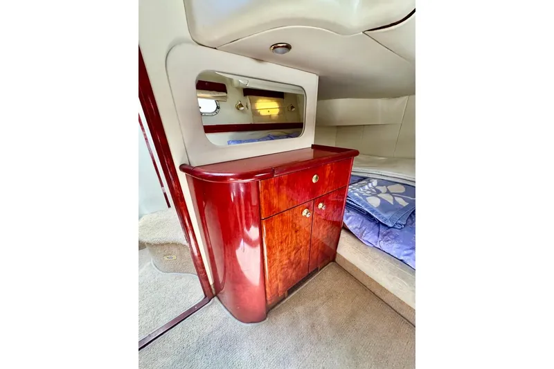 Slide: The Image of Luxurious cabin interior of 1999 Birchwood Challenger 450 Flybridge with polished wood cabinetry. - 43