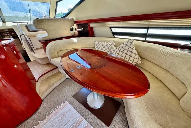 Slide: The Image of Luxurious interior of 1999 Birchwood Challenger 450 Flybridge with elegant seating and wooden table. - 16