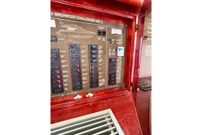 Slide: The Image of Control panel of a 1999 Birchwood Challenger 450 Flybridge yacht, featuring switches and indicators. - 18