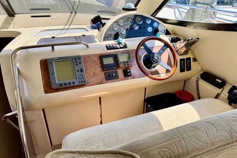 Slide: The Image of Interior helm of 1999 Birchwood Challenger 450 Flybridge with steering wheel and navigation instruments. - 20
