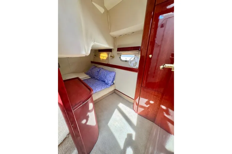 Slide: The Image of Cozy cabin interior of 1999 Birchwood Challenger 450 Flybridge with plush bedding and wooden accents. - 41