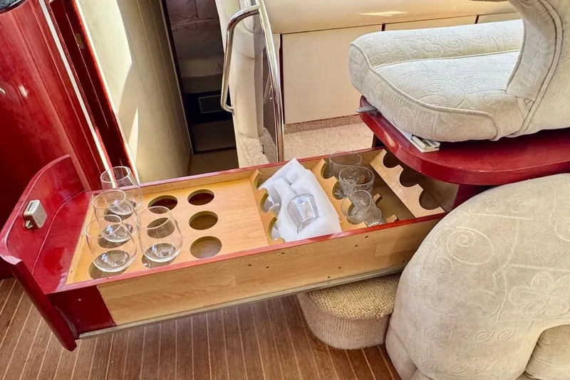 Slide: The Image of Interior of 1999 Birchwood Challenger 450 Flybridge with glassware storage drawer. - 30