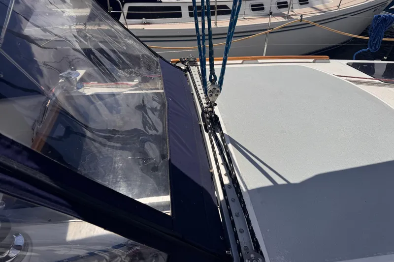 Slide: The Image of 1993 Hunter 33.5 sailboat deck with rigging and clear canopy in marina. - 23