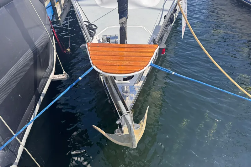 Slide: The Image of Bow of a 1993 Hunter 33.5 sailboat with anchor and wooden platform. - 25