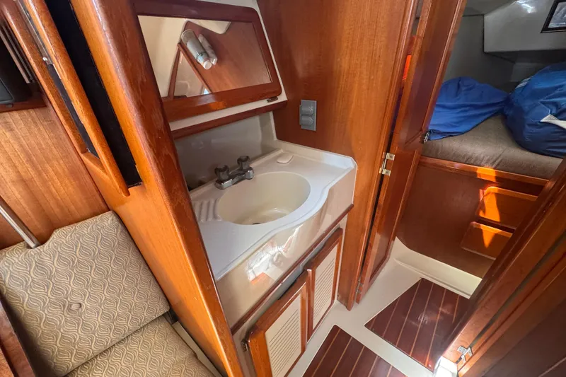 Slide: The Image of Interior of 1993 Hunter 33.5 sailboat featuring a compact bathroom sink area. - 35