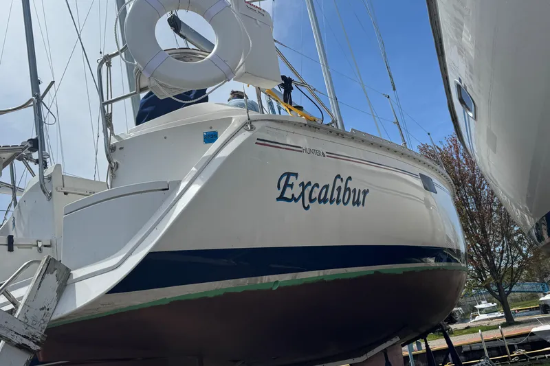 Slide: The Image of Sailboat "Excalibur" on land, 1993 Hunter 33.5 model, with visible life ring. - 3