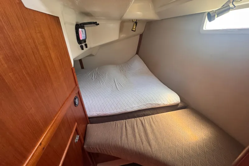 Slide: The Image of Cozy cabin interior of 1993 Hunter 33.5 sailboat with bed and wooden paneling. - 43