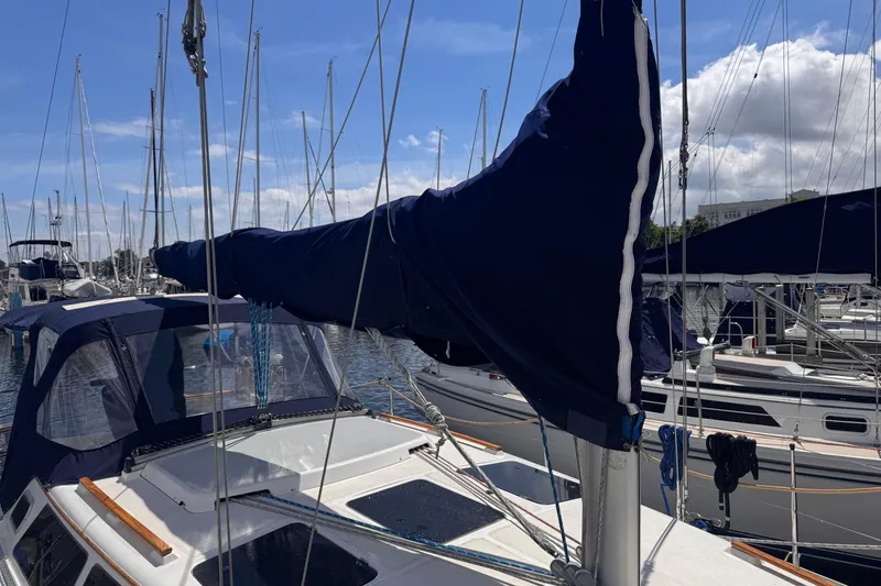 Slide: The Image of Sailboat Hunter 33.5, 1993 model, docked at marina with covered sails. - 24