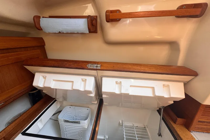 Slide: The Image of Interior of a 1993 Hunter 33.5 sailboat showing a compact kitchen storage area. - 27