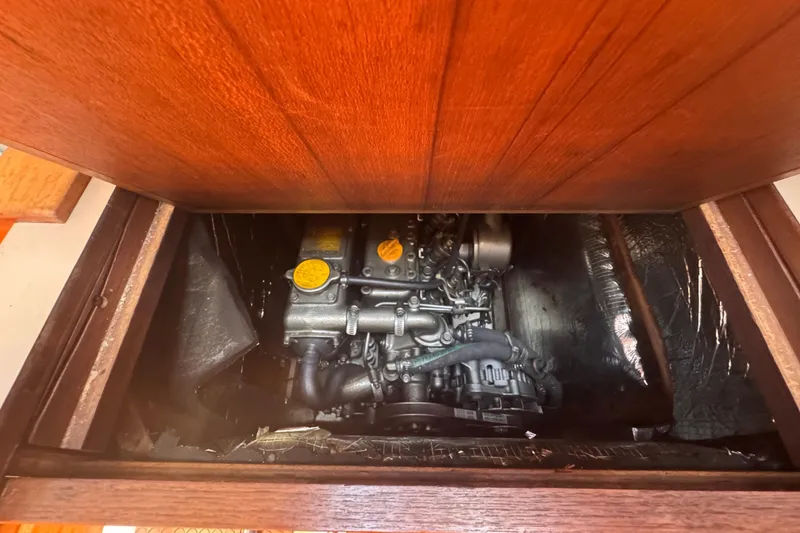 Slide: The Image of Engine compartment of a 1993 Hunter 33.5 sailboat, showcasing mechanical components. - 44