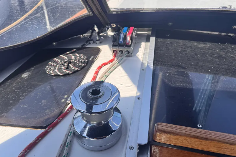 Slide: The Image of Cockpit of a 1993 Hunter 33.5 sailboat featuring winch and control lines. - 11