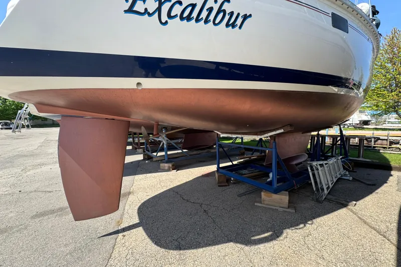Slide: The Image of Hunter 33.5 sailboat "Excalibur" on stands, showcasing hull and keel, 1993 model. - 5