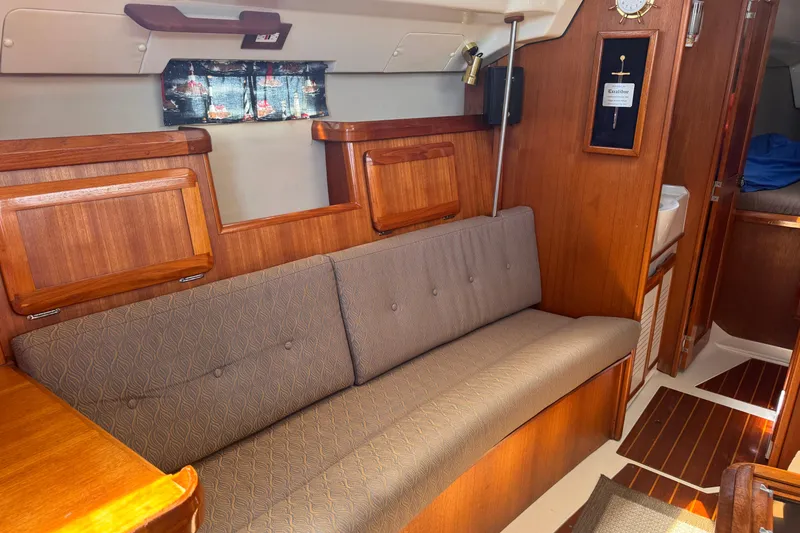 Slide: The Image of Interior of a 1993 Hunter 33.5 sailboat with wooden cabinetry and cushioned seating. - 31