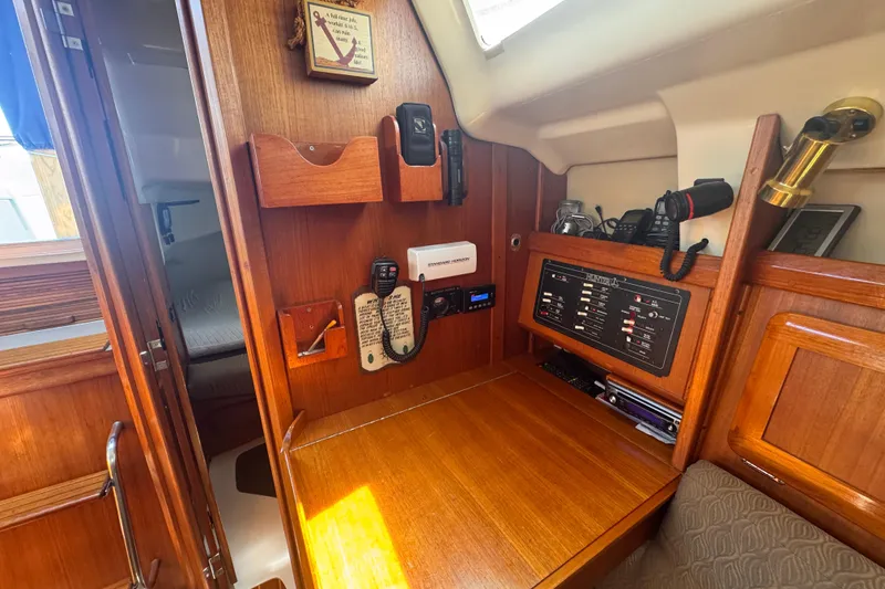 Slide: The Image of Interior of a 1993 Hunter 33.5 sailboat with navigation equipment and wooden cabinetry. - 41