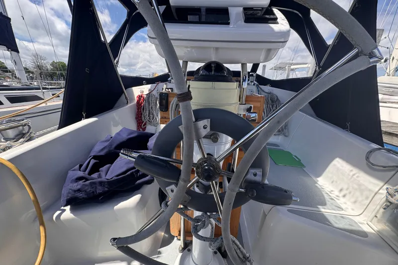 Slide: The Image of Cockpit of a 1993 Hunter 33.5 sailboat with steering wheel and navigation equipment. - 18