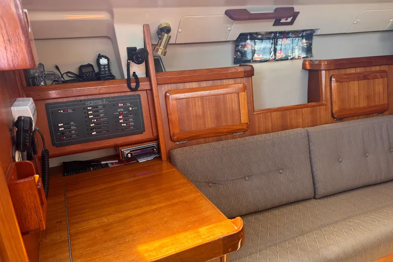 Slide: The Image of Interior of a 1993 Hunter 33.5 sailboat with wooden cabinetry and control panel. - 30