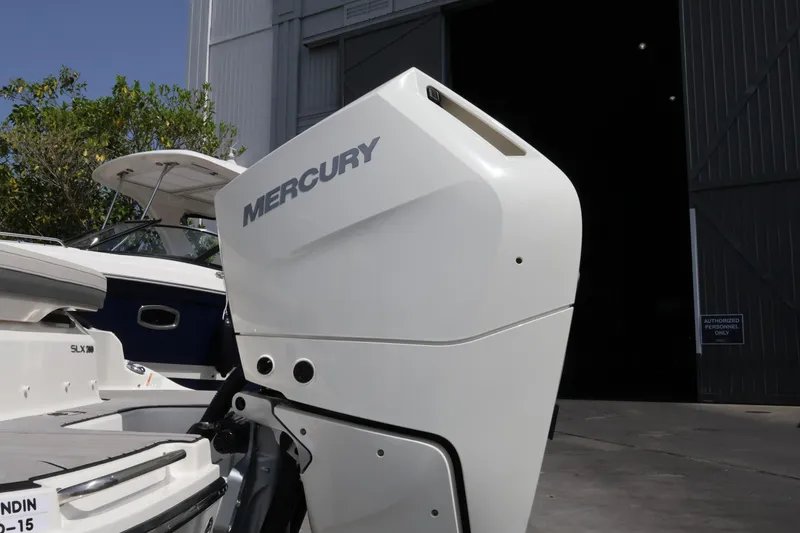 Slide: The Image of 2024 Sea Ray SLX 260 Outboard with Mercury engine, docked near a building. - 11