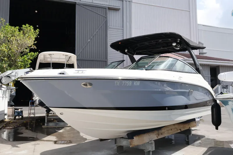 Slide: The Image of 2024 Sea Ray SLX 260 Outboard boat displayed in a marina setting. - 6