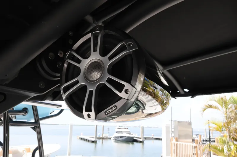 Slide: The Image of Fusion marine speaker on 2024 Sea Ray SLX 260 Outboard, docked by the water. - 39