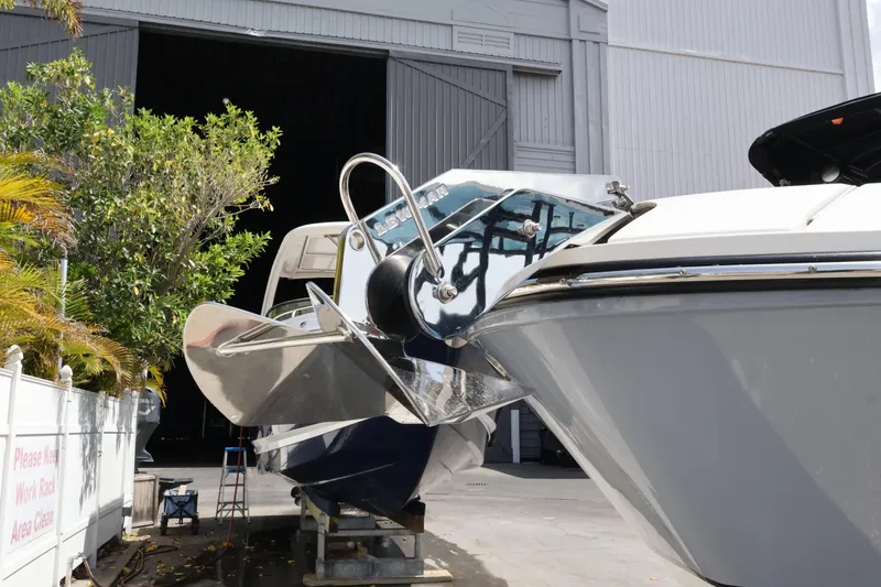 Slide: The Image of 2024 Sea Ray SLX 260 Outboard boat docked near a storage facility. - 12