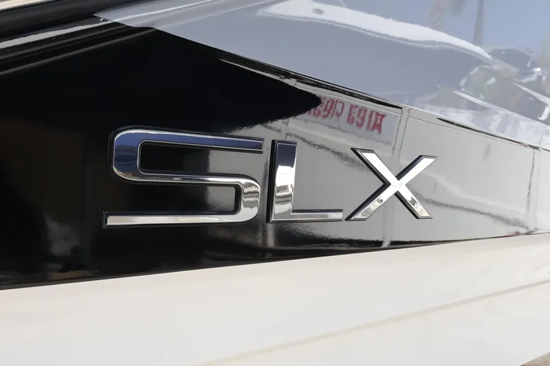 Slide: The Image of 2024 Sea Ray SLX 260 Outboard logo on sleek black surface. - 7