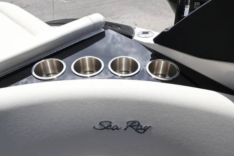 Slide: The Image of 2024 Sea Ray SLX 260 Outboard boat interior with cup holders and logo. - 36