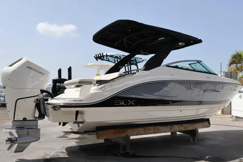 Slide: The Image of 2024 Sea Ray SLX 260 Outboard boat with Mercury engine, docked on a sunny day. - 3