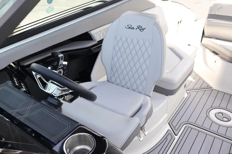 Slide: The Image of 2024 Sea Ray SLX 260 Outboard helm with luxurious seating and modern steering wheel design. - 26
