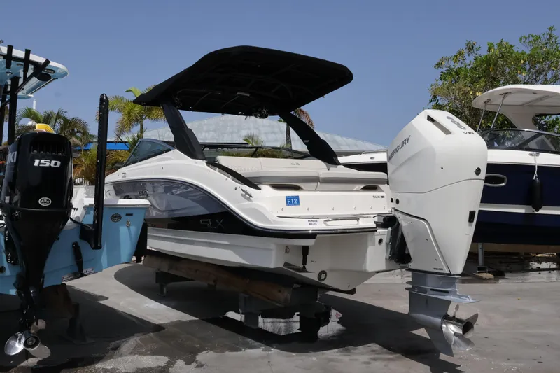 Slide: The Image of 2024 Sea Ray SLX 260 Outboard boat with Mercury engine, docked outdoors. - 9