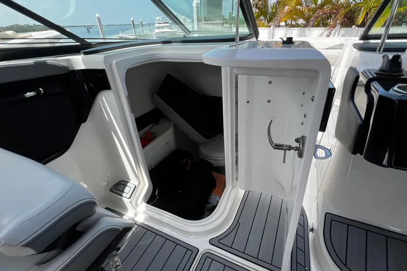 Slide: The Image of 2024 Sea Ray SLX 260 Outboard interior cabin with open door, showcasing sleek design. - 29
