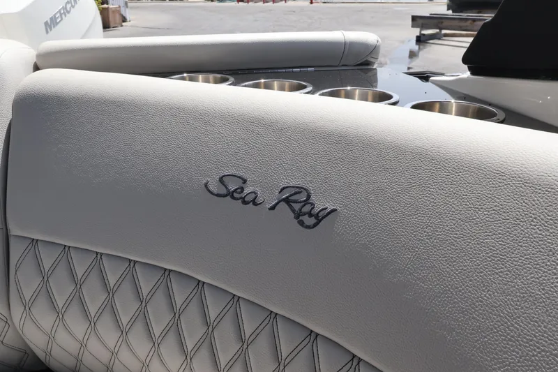 Slide: The Image of 2024 Sea Ray SLX 260 Outboard boat interior with embroidered logo and cup holders. - 35