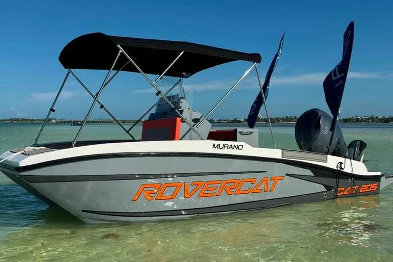 Slide: The Image of 2026 Murano 205 Rovercat boat with canopy on clear water. - 2