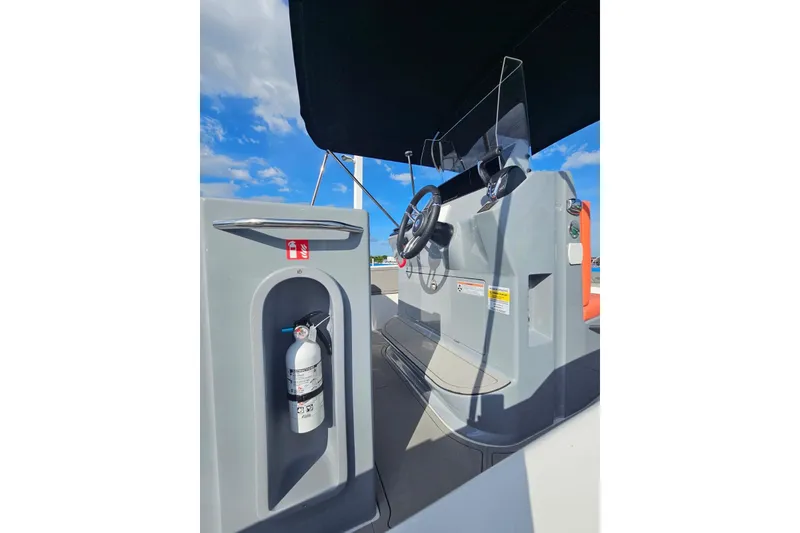 Slide: The Image of 2026 Murano 205 boat cockpit with steering wheel and fire extinguisher under clear blue sky. - 33
