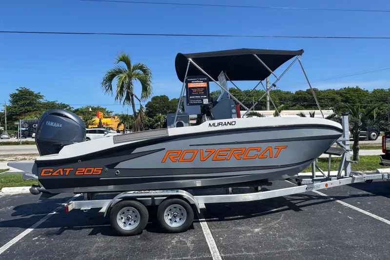 Slide: The Image of 2026 Murano 205 Rovercat boat on trailer, featuring Yamaha engine and canopy. - 11