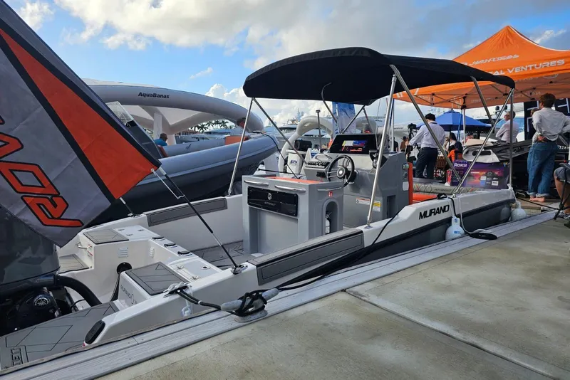 Slide: The Image of 2026 Murano 205 boat displayed at a marina event under a sunny sky. - 21