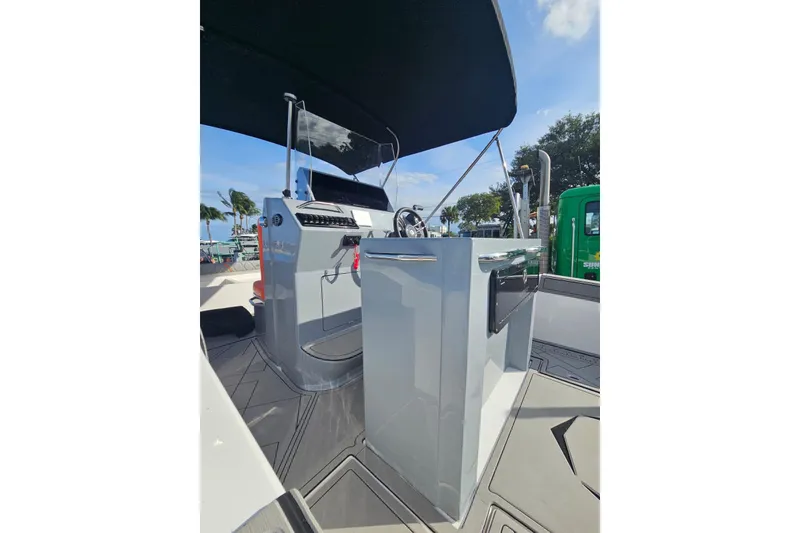 Slide: The Image of 2026 Murano 205 boat cockpit with modern controls and sleek design under a sunny sky. - 30