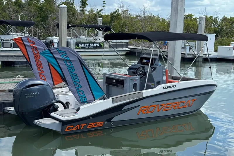 Slide: The Image of 2026 Murano Rovercat 205 boat docked with Yamaha engine, featuring sleek design and canopy. - 17