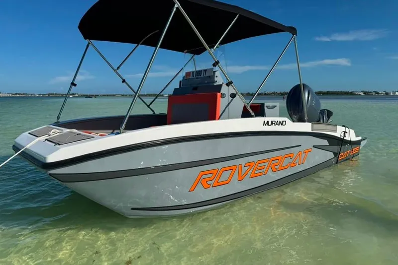 The Image of 2026 Murano 205 Rovercat boat in shallow water, featuring sleek design and canopy. - 1
