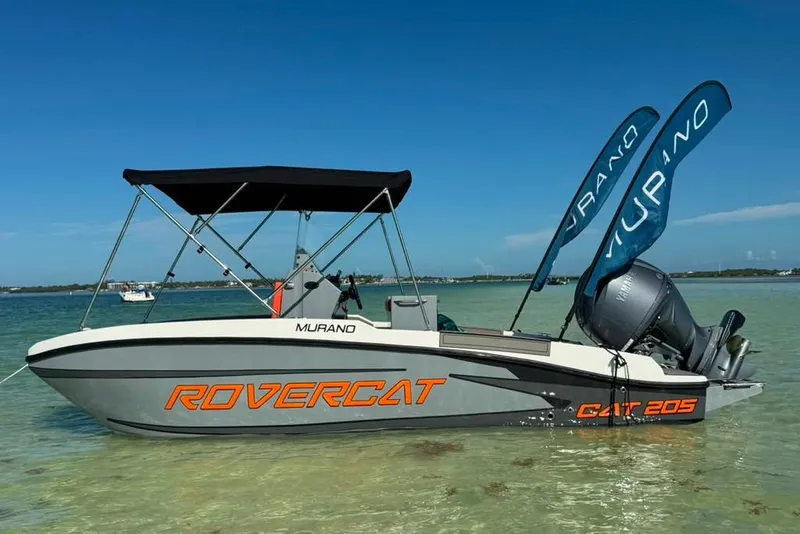 Slide: The Image of 2026 Murano 205 Rovercat boat with canopy on clear water. - 3